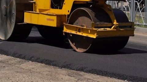 Road roller works on the construction of a new asphalt road. Road repair. Making Stock Footage 169497995
