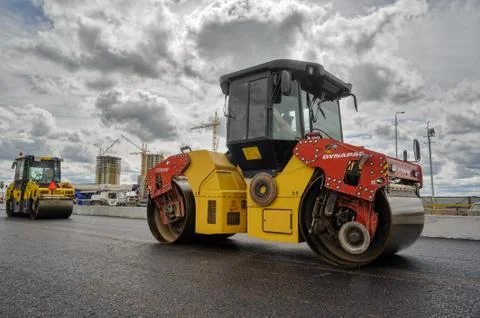 Road rollers compressing asphalt to highway Stock Photos