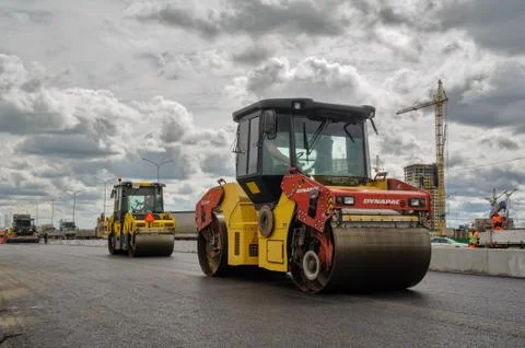 Road rollers compressing sand to highway Stock Photos
