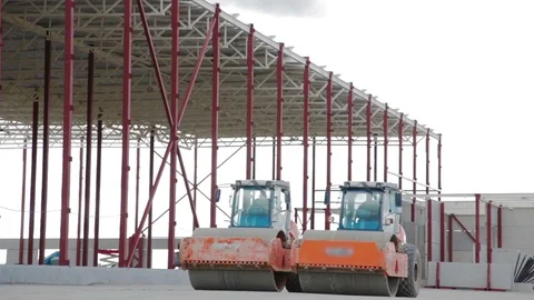 Road rollers doing road repair near new warehouse 스톡 동영상 90997992