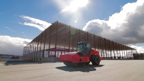 Road rollers doing road repair near new warehouse Stock Footage 91005395