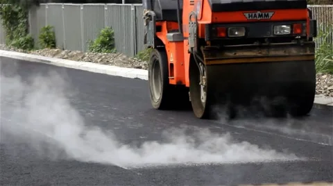 Road rollers flattens asphalt while concrete smoking by Pakito. Stock Footage 41728323