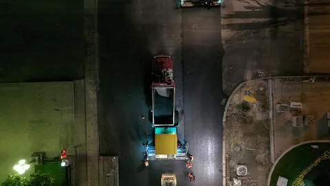 Road rollers leveling fresh asphalt pavement at the crossroads of the city by Video stock 113996884