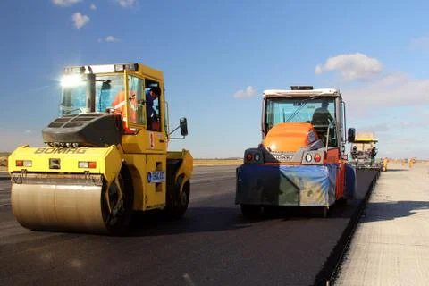 Road rollers leveling fresh asphalt pavement Stock Photos
