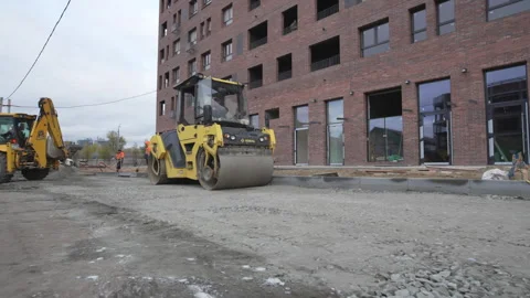 Road rollers move in unison with excavator in repair zone Stock Footage 306552401