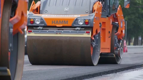 Road rollers working on city street. Industrial machinery on construction road. Stock Footage 132997165