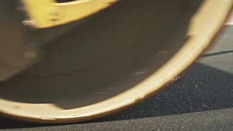 Road rollers of yellow colour drive on new asphalt highway Stock Footage 134460627