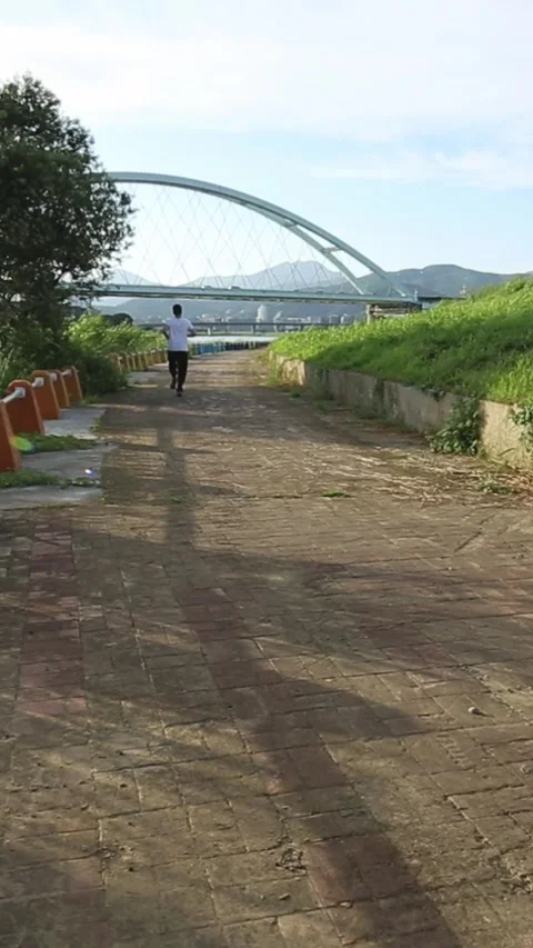 Road runner caucasian man running near the river in Taipe city Stock Footage 315520390