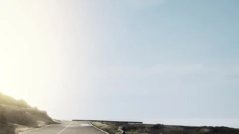 Road running along the coastline with clear sky in the background Stock Footage 343496084