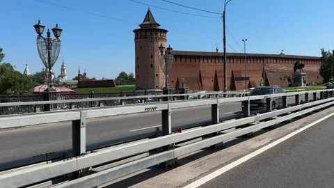 Road running alongside an ancient red brick Kremlin in a historic cit Stock Footage 313978379