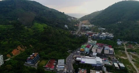 Road running down a green saddle toward open sea 库存影片 71300920