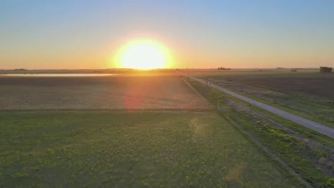 Road running through the Pampas in La Pampa, Argentina, sunset drone Stock Footage 163486869