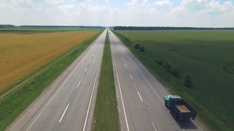 The road in rural areas passes between fields Stock Footage 77716793