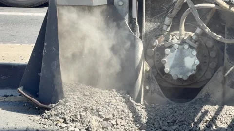 Road saw blade cuts through asphalt pavement creating opening during urban road Stock Footage 334321737