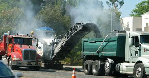 Road scraping machine removes old asphalt during construction in Los Angeles, 4K Stock Footage 94037605