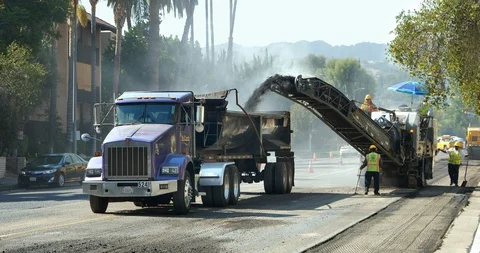 Road scraping machine removes old asphalt during construction in Los Angeles, 4K Stock Footage 94041904