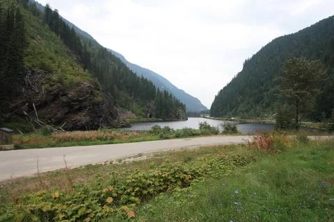 A road side shot of a lake while travelling through a mountain range. Stock Photos