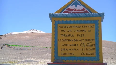 Road sign and prayer flags at Taglang La Pass in Ladakh, India Stock Footage 47148579