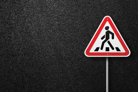 Road sign on a background of asphalt. Stock Photos