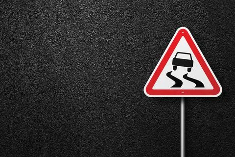 Road sign on a background of asphalt. Stock Photos