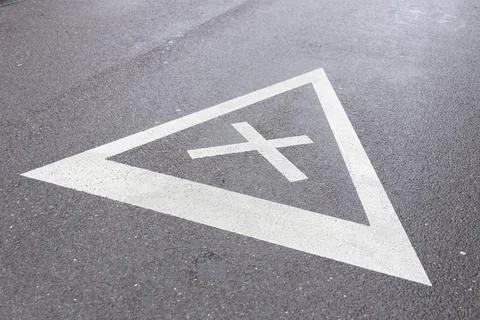 Road sign of equal intersection painted on asphalt Stock Photos