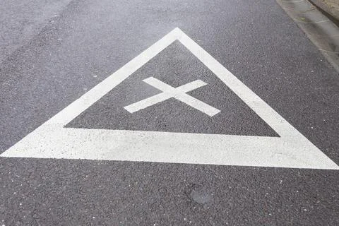 Road sign of equal intersection painted on asphalt Stock Photos