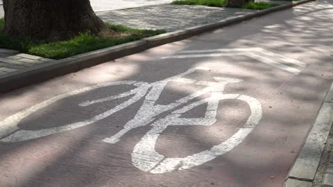 A road sign indicating a cycle path is engraved in white on the ground Stock Footage 237895116
