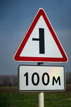 Road sign intersection. turn left. the road sign starts working after a hundred Stock Photos