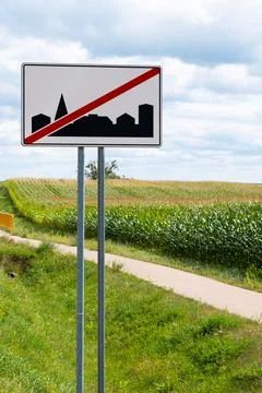 Road sign marking the end of a built-up area beside a rural road Stock Photos