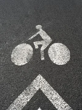 Road sign painted on the ground indicating bike lane Stock Photos