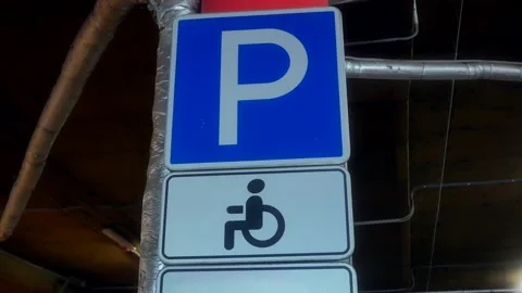 Road sign on parking site with warning about place for disabled people Stock Footage 199686857