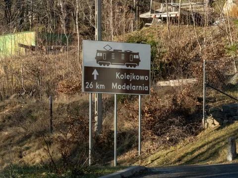 A road sign pointing toward a model railway exhibition, displaying a train icon Stock Photos