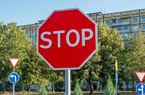 Road sign "stop" instructing drivers to stop completely Stock Photos