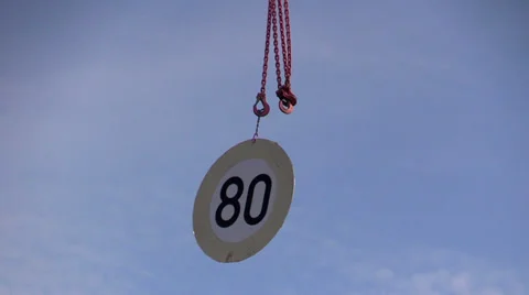 Road sign in the wind on an iron hook of a crane Stock Footage 37860182