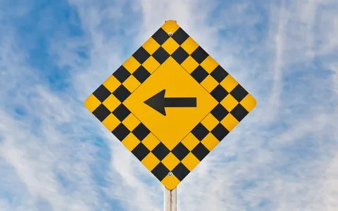 Road Sign withLeft Arrow Isolated on against a Dramatic Blue Sky Stock Photos