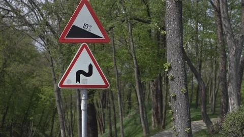 Road signs on the background of a spring forest with trees on a sunny day. Close Video stock 107144202