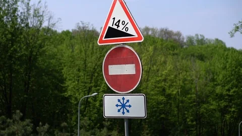 Road signs on the background of a spring forest with trees on a sunny day. Close Stock Footage 107446095