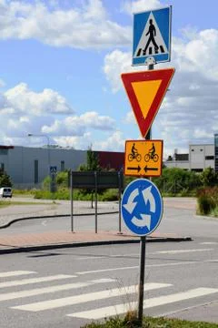 Road signs at intersection roundabout Stock Photos