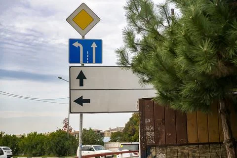 Road signs with pointers against a cloudy sky. Stock Photos