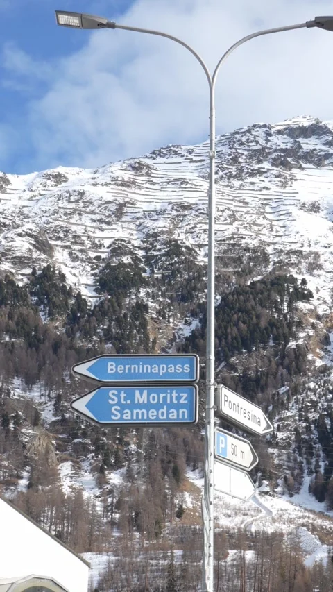 Road signs to st. Moritz and bernina pass in the swiss alps in pontresina 스톡 동영상 329624007