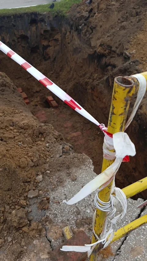 Road signs warning of construction work and a ban on travel. The dug-out pit is Stock Footage 317669724