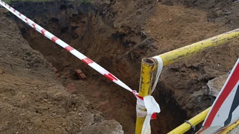 Road signs warning of construction work and a ban on travel. The dug-out pit is Stock Footage 317669727