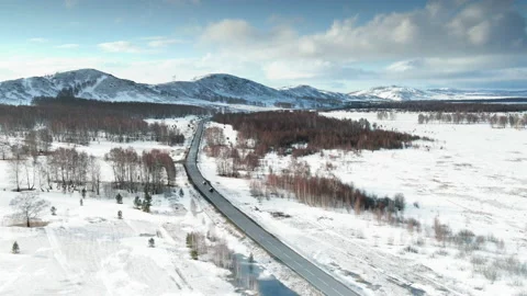 Road in the snow-covered mountains. Video stock 152075265