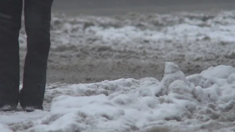 Road in the snow during a snowfall in winter. Cars drive through a road covered Stock-Footage 83775294