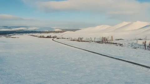 Road by the snow field at the dusk. Stock Footage 70386801