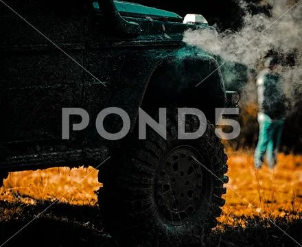 Off road sport truck between mountains landscape. Tracks on a muddy field Stock Photos