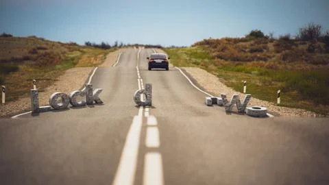 Road with stone letters LOCKDOWN. The letters are in disarray on the track. The Stock Photos
