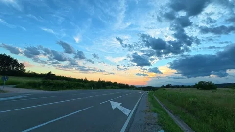 Road stretches ahead under a vast, dramatic sky. Mount Rtanj Area, Serbia Stock Footage 340898944
