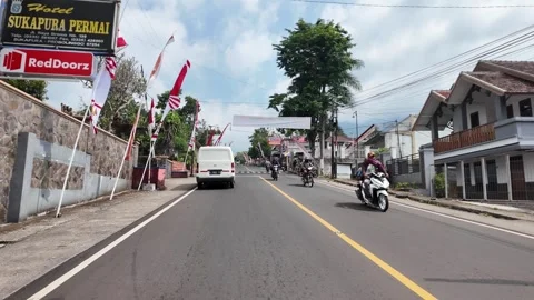 Road stretches under bright sky with clouds above Stock Footage 345193509