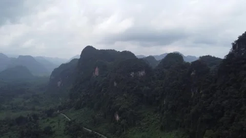 Road Stretching into Forest Among Mountains Stock Footage 255041415